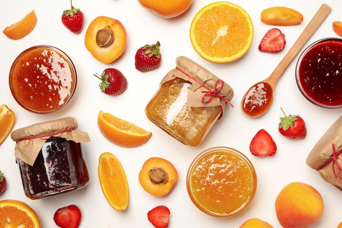 Composition with jam and ingredients on plain background, top view