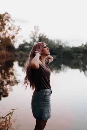 Stylish woman on lake shore