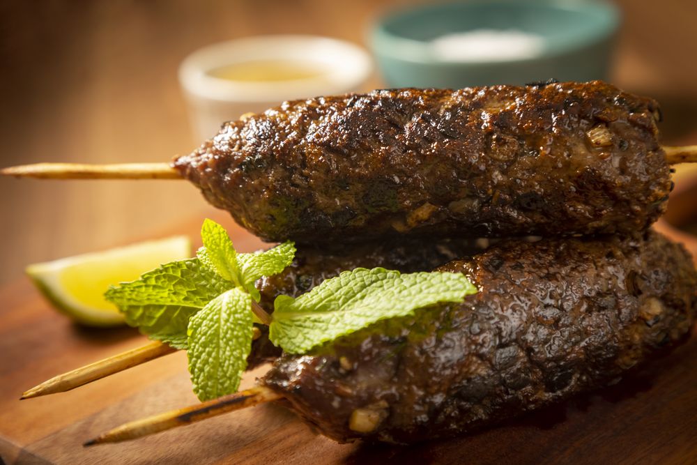 Beef kafta on the wooden board. Kafta, Traditional Arabic cuisine.