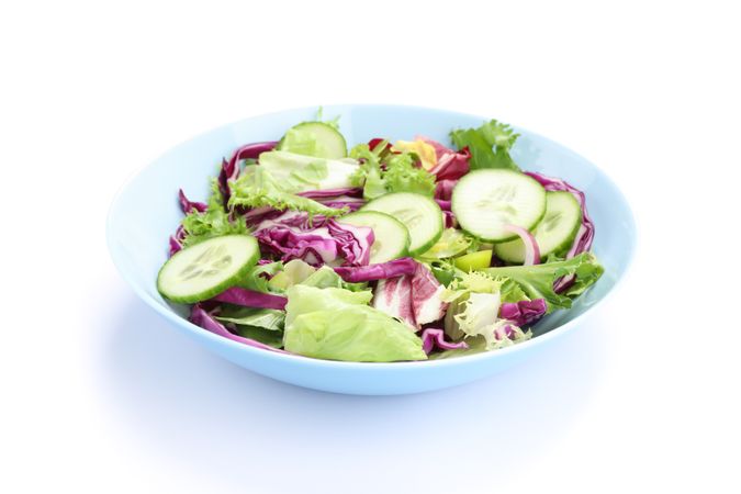 Plate with fresh salad isolated on plain background