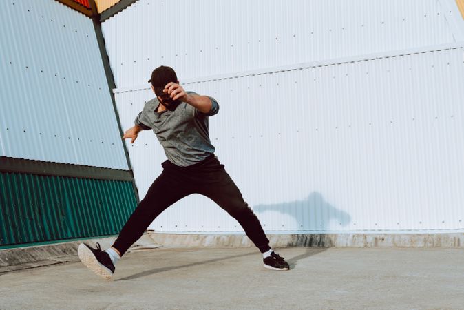 Man performing near wall