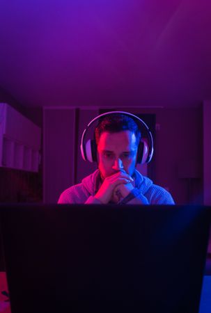 Man listening cheerfully to music with headphones.