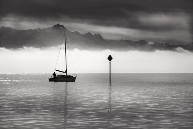 Monochrome image of a single boat sailing