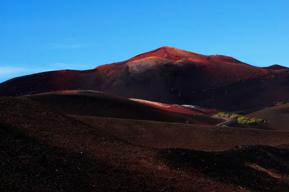 Picturesque view of volcanic terrain with solidified lava in wild area