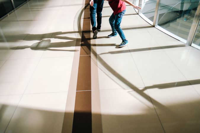Two people in a sunny atrium