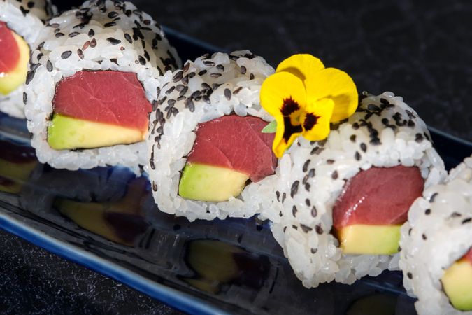 Delicious sushi rolls with avocado and tuna