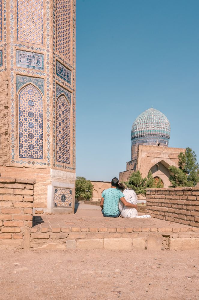 Couple sitting outside ornamental building