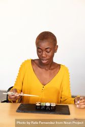 Black woman eating sushi 5XRz7b