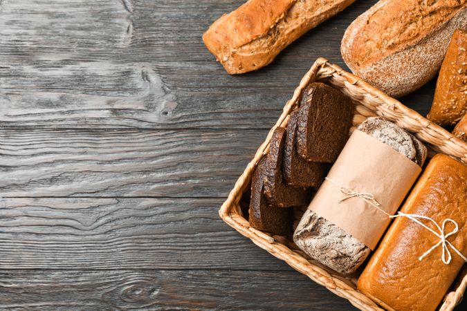 Flat lay composition with bakery products on wooden background, top view and space for text