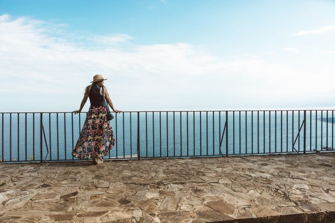 Stylish woman on terrace of seashore