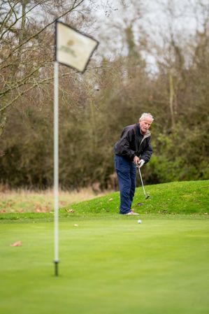 Man putting on golf course