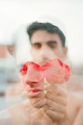 Young man with red flowers