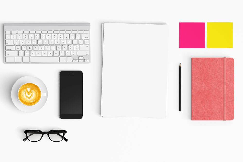 Modern workspace with coffee cup, smartphone, paper, tablet and notebook copy space
