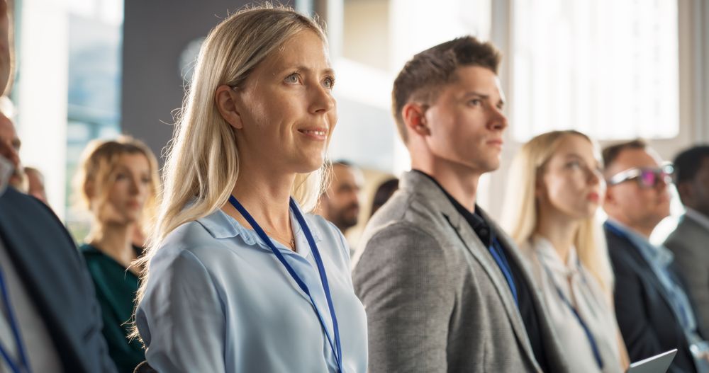 Close Up: Female Top Manager Sitting in Crowded Auditorium at a Tech Conference.