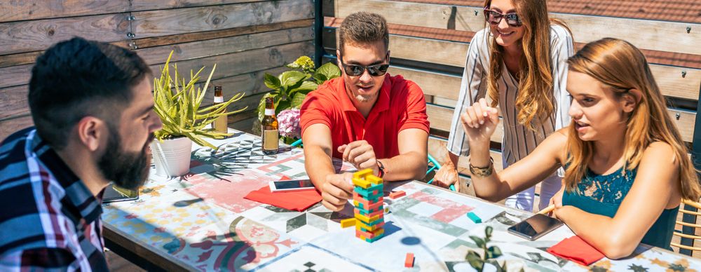 Group of friends playing with game in rooftop on a summer party