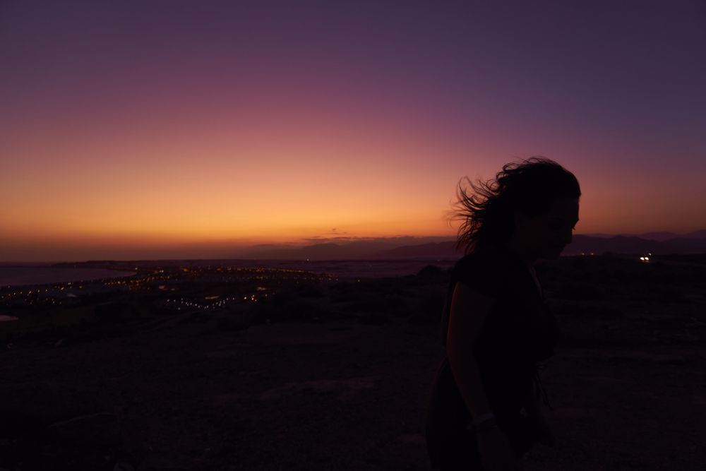 Silhouette of female enjoying picturesque sunset
