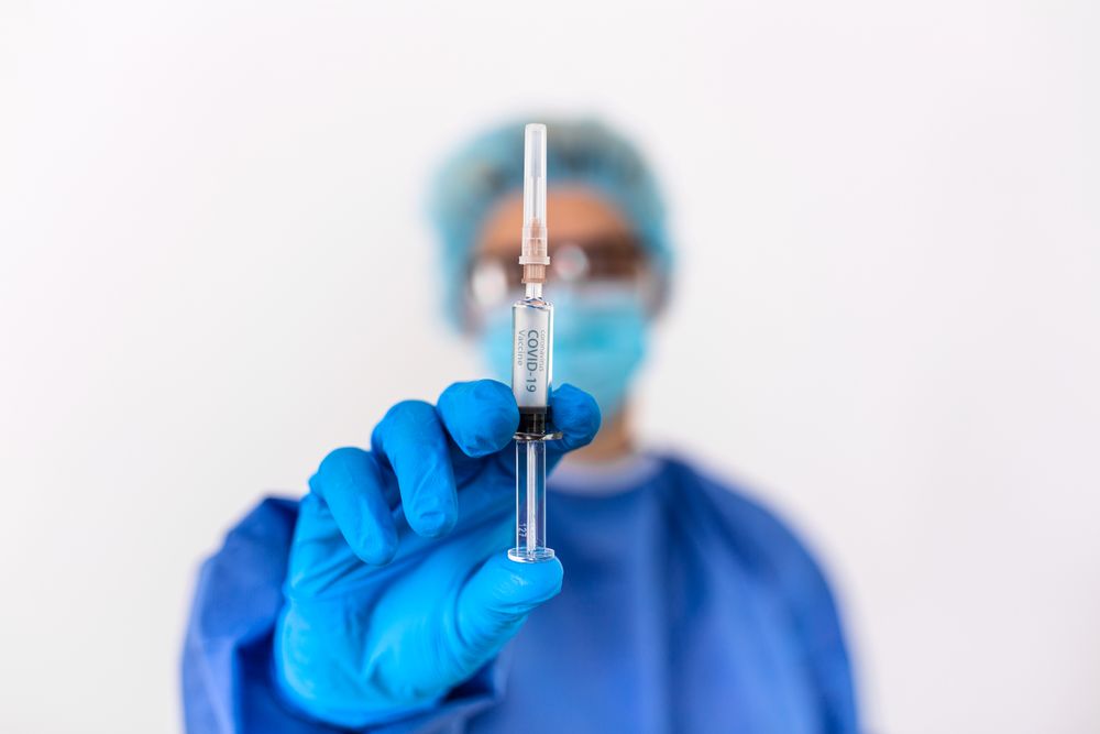 Healthcare worker holding needle
