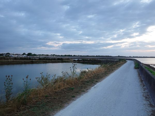 Bike path along dike to the Port of Loix, France.
