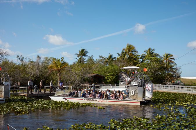 Airboat full of passengers on Everglades swamp tour