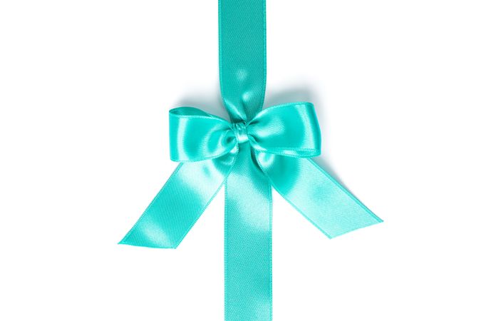 Turquoise ribbon with bow isolated on plain background. Gift concept
