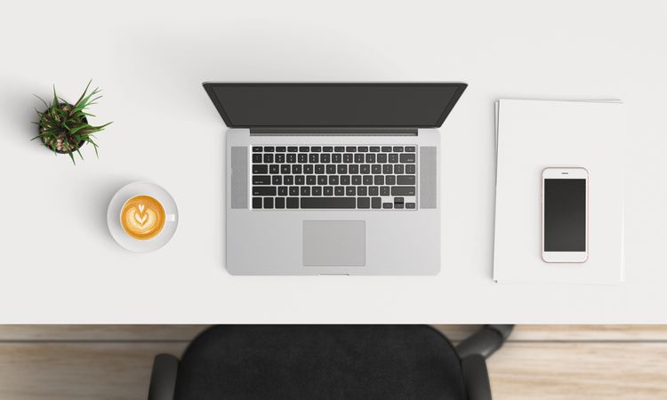Modern workplace with laptop and smartphone copy space on table background. Top view. Flat lay style.
