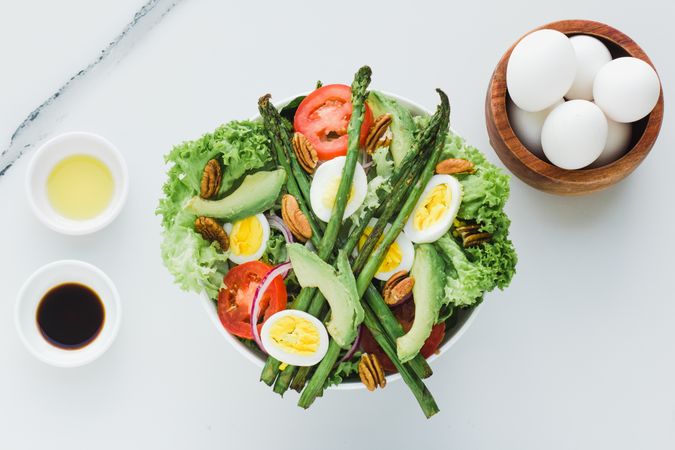 Salad with asparagus eggs avocados tomatoes and walnuts