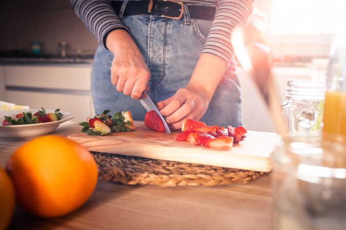 Woman cutting fruits in kitchen