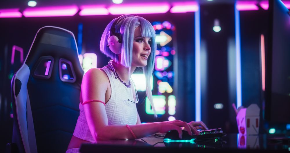 Portrait of a Happy Cosplayer in Headphones Talking with Friends Online on a Computer.