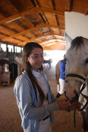 Girl with adorable pony in hat