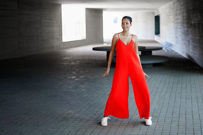 A Fashionable Model in an EyeCatching Red Jumpsuit Posing Confidently for the Camera