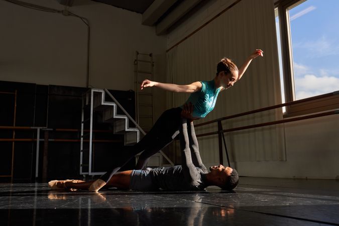 Male and female dancer in a class doing a training in ballet academy
