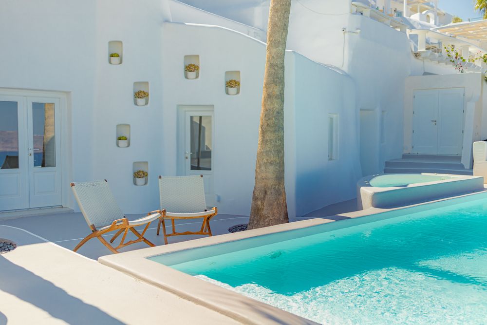Two seats next to a pool in Greece