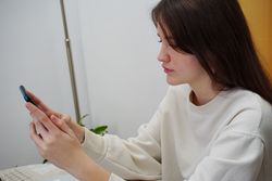 Side view of teenage girl using smartphone