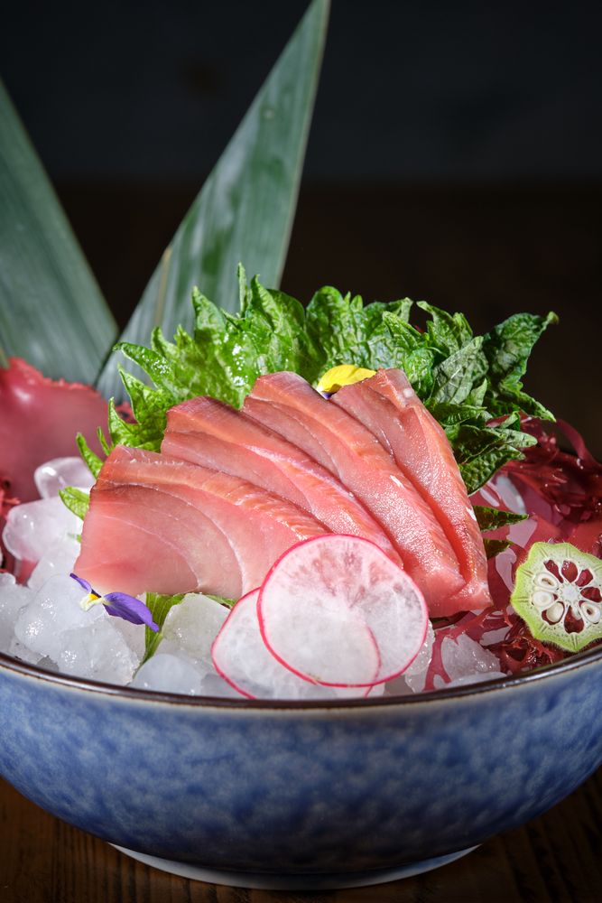 Ceramic plate with raw fish and vegetables
