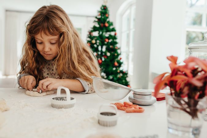 Little girl making cookies for Christmas.