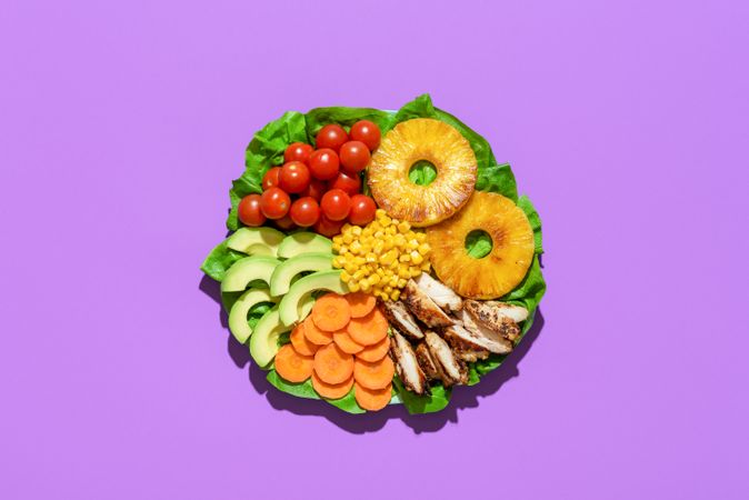 Hawaiian salad plate above view on purple background