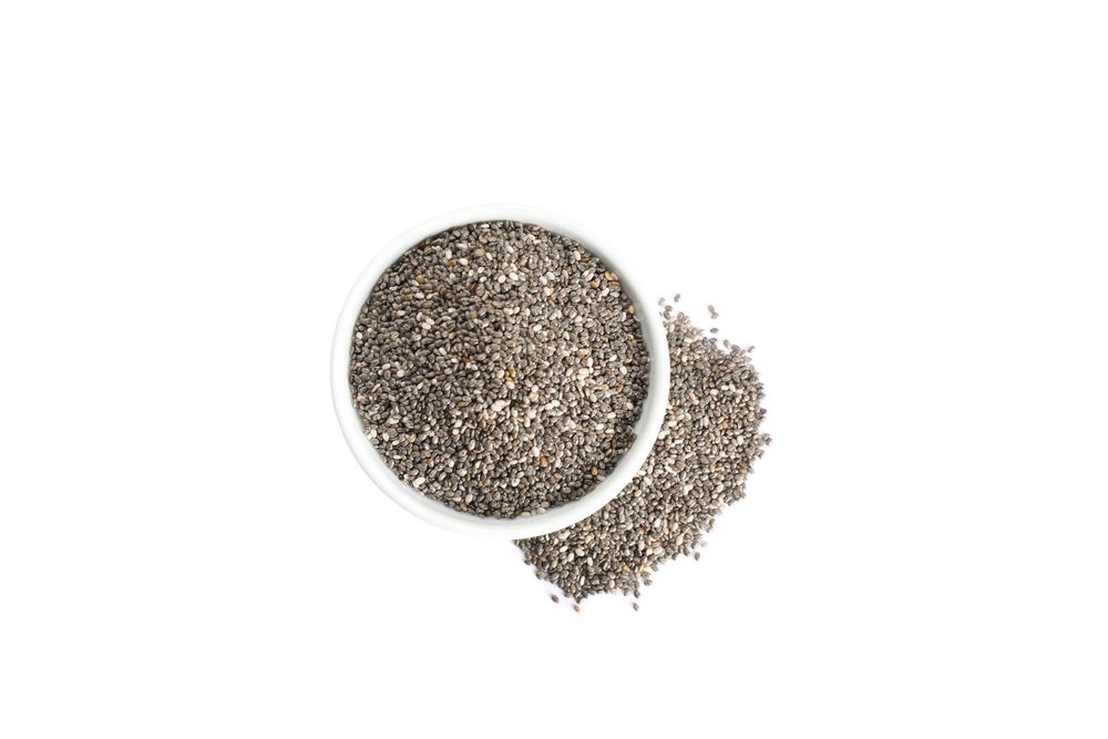 Chia seeds and sauce boat isolated on plain background