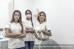 Group of a female dental staff in medical center standing near the chair bDyGk0
