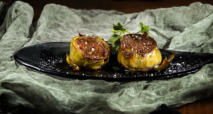 Delicious baked artichokes on plate