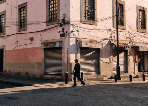 Man walking on empty morning street in Mexico City