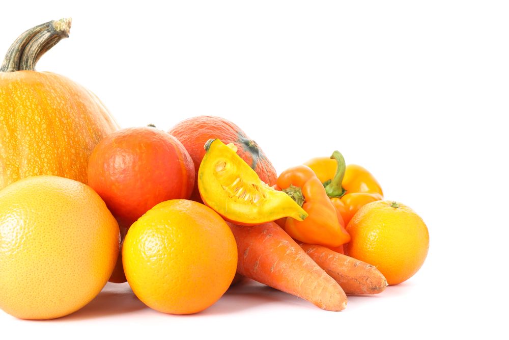 Pumpkins, oranges, carrot and peppers isolated on plain background