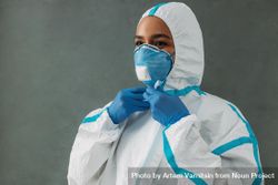 Black woman in hazmat suit, protective gloves and face mask 5o9xxb