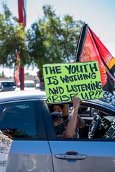 Los Angeles, CA, USA — June 7th, 2020: man holding protest sign out of car window at rally