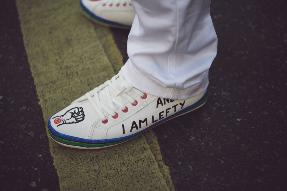 London, England, United Kingdom - March 19 2022: “I am lefty” on canvas sneakers