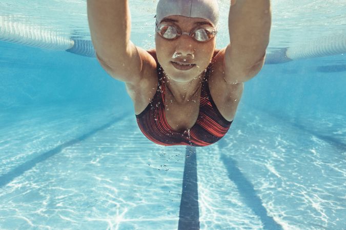 Underwater shot of female swimmer swimming inside pool