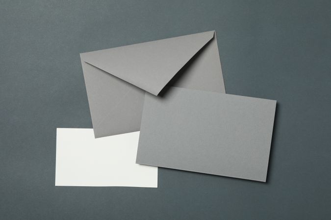 Blank envelope and cards on light dark background, space for text