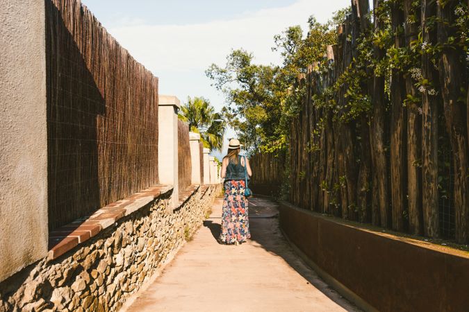 Woman walking in narrow path