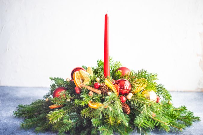 Center piece on Christmas table with fir, baubles and candle