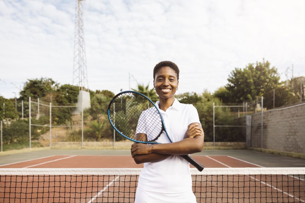 Young women with a racket in a tennis court