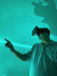 Man wearing virtual reality headset in green lit room